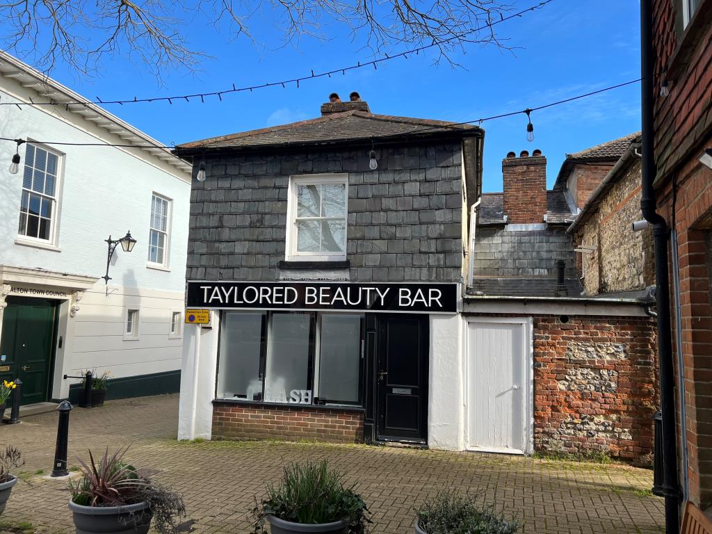 Lot: 5 - FREEHOLD TOWN CENTRE INVESTMENT - Rear view of a pair of shops in Alton Town Centre